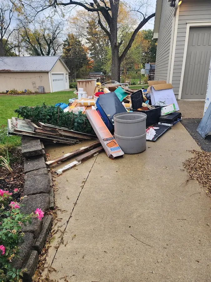 Dumpster being loaded with debris for Estate Cleanout Dumpster Rental in Rochelle